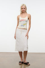 Cream sleeveless graphic camisole top with red-blue text and vehicle print