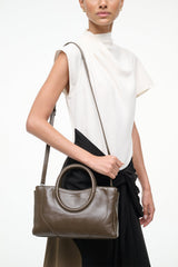 Mini satchel bag in truffle brown with long shoulder strap and oval top handles