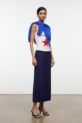 Floral black mule shoes with low kitten heel, worn with a navy pleated skirt