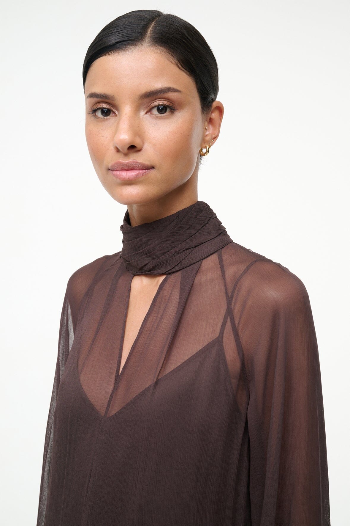 Brown high-neck maxi dress with sheer overlay and V-shaped neckline