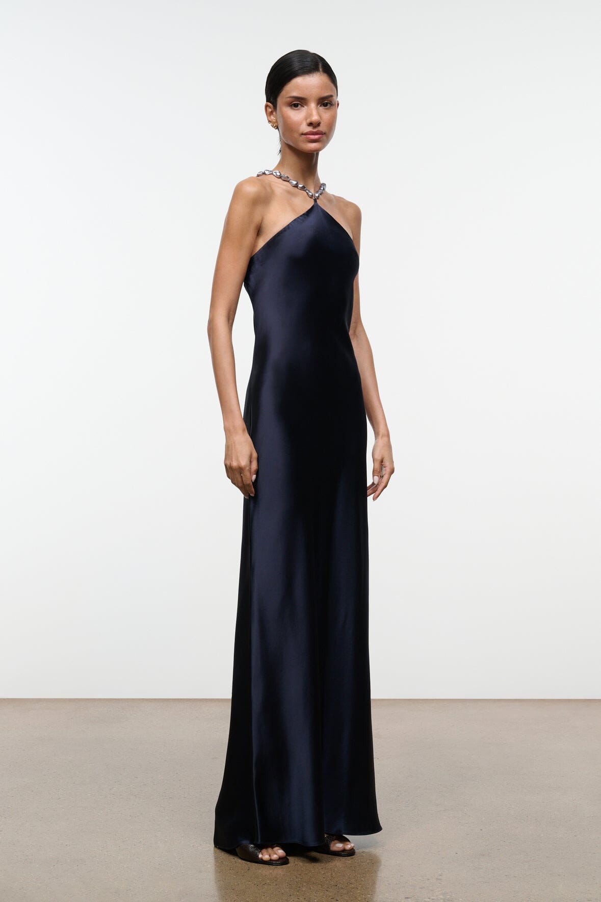 Navy halter satin maxi dress with beaded halter strap, sleeveless drape