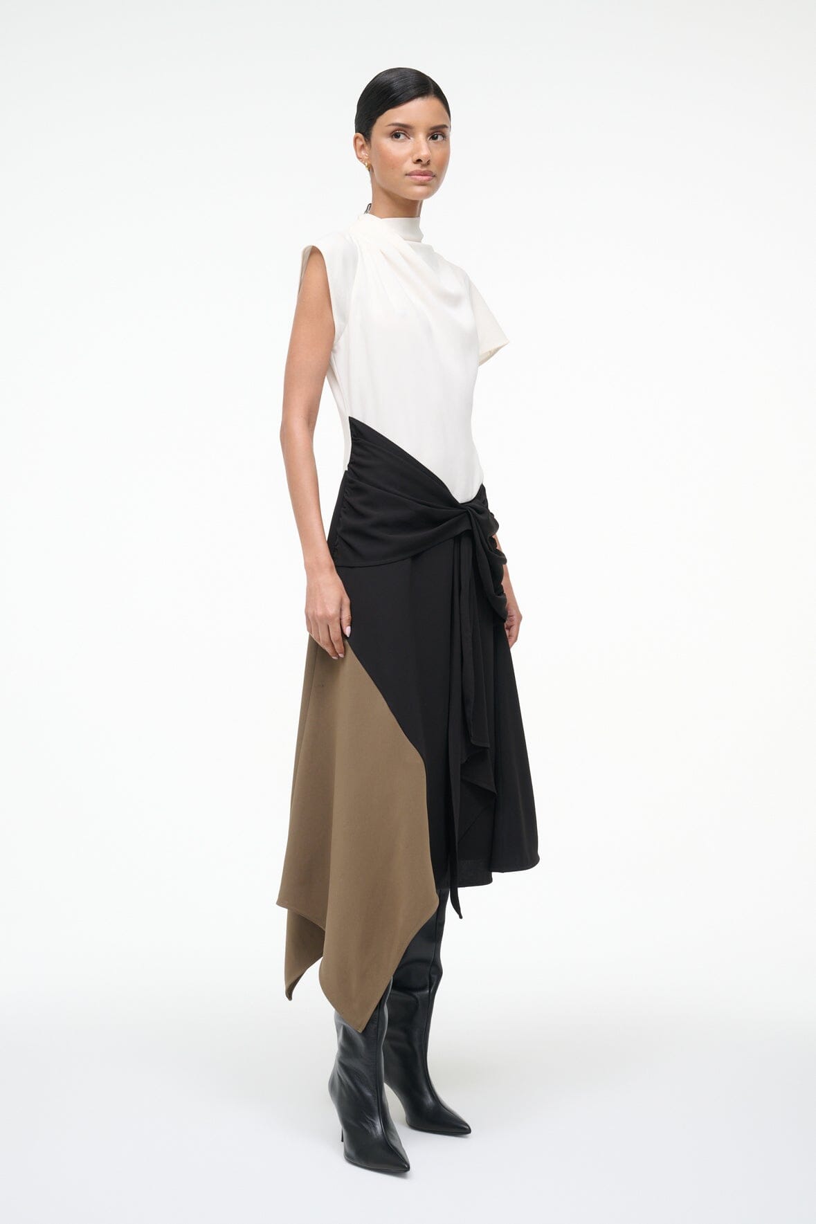 Sleeveless high-neck dress, side view, white top with black wrap drape over tan panel