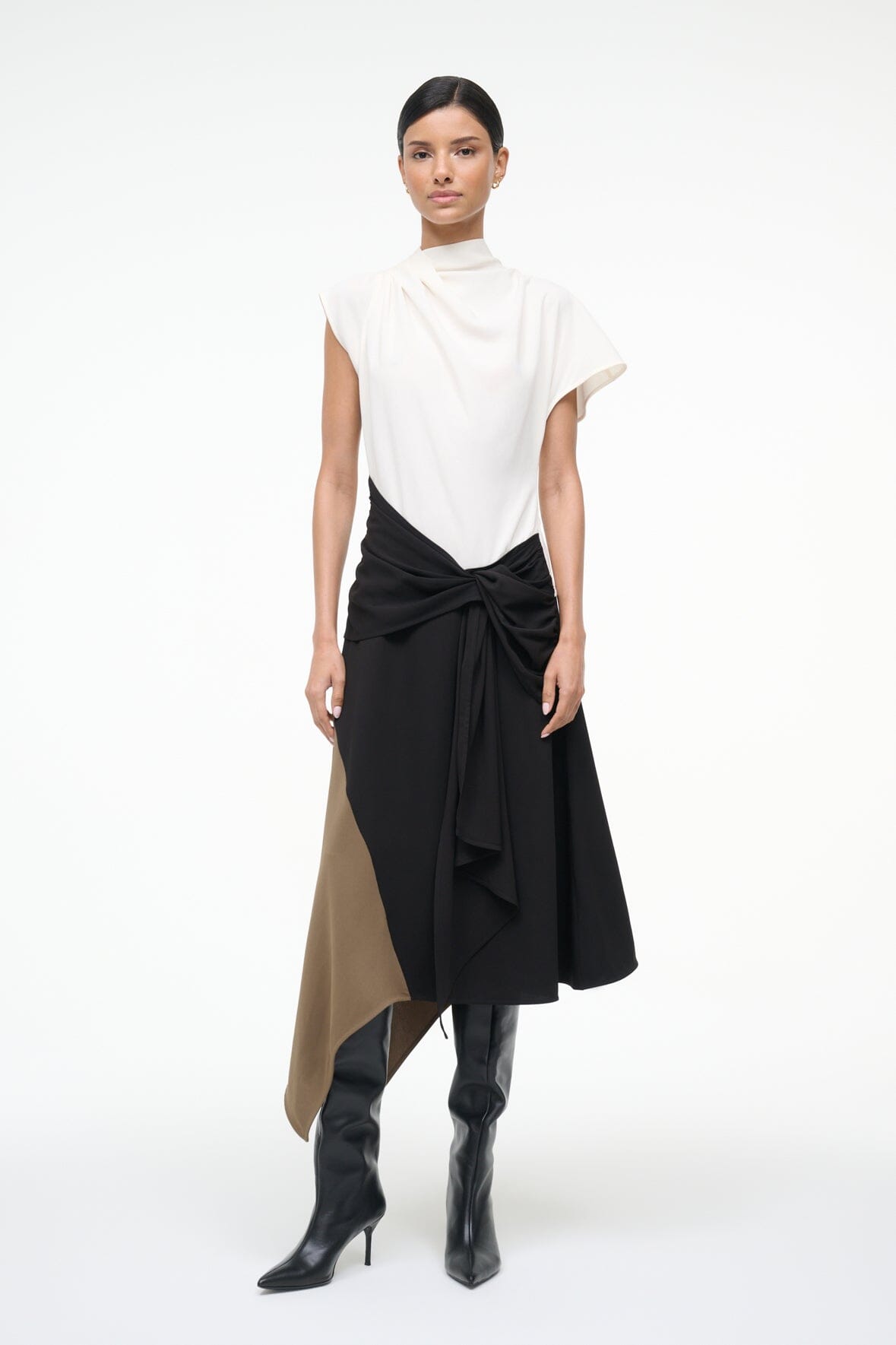 Sleeveless high-neck dress with white upper and black knotted waist, asymmetrical tan panel