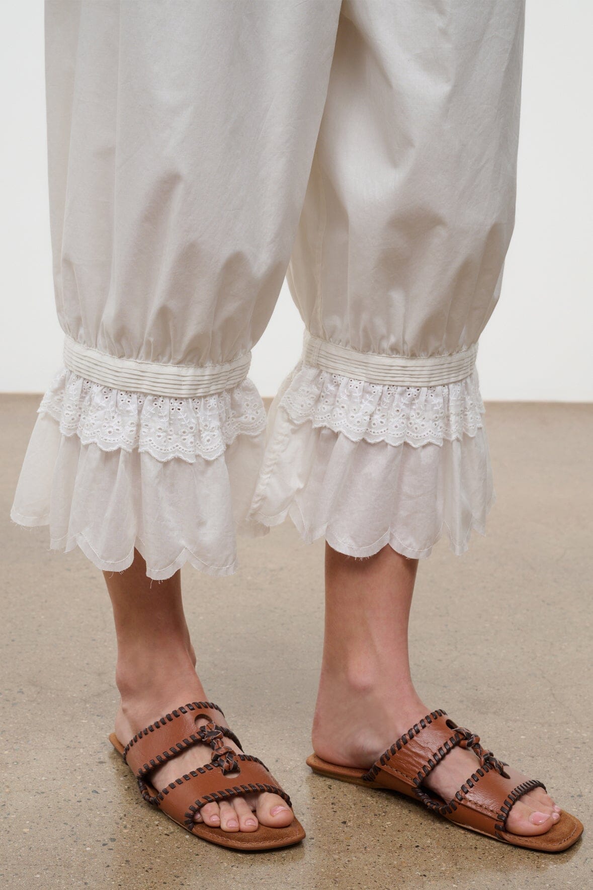 Tan slide sandals with braided straps and open toe