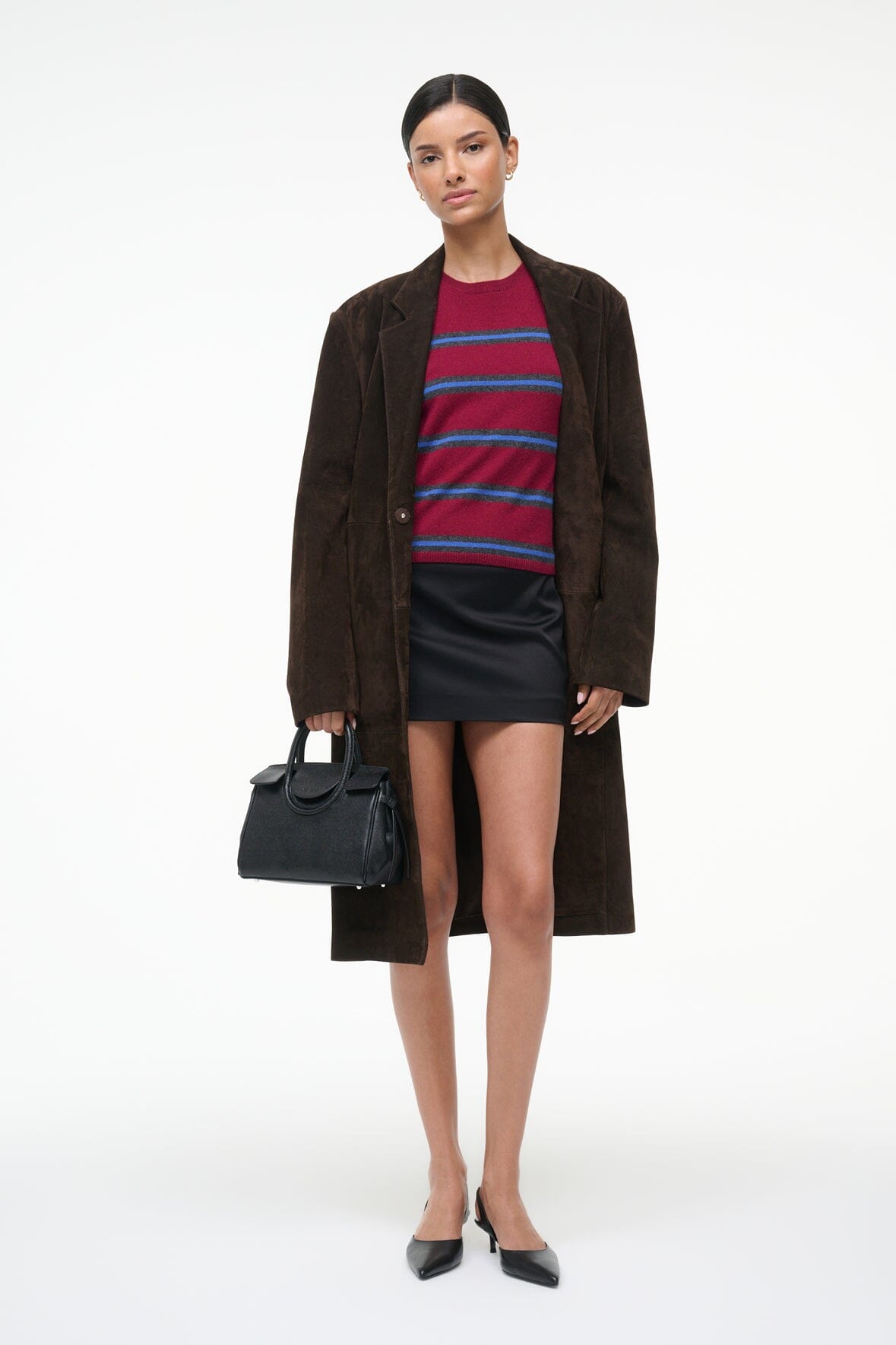 Crimson cashmere tee with horizontal blue/navy stripes under dark overcoat