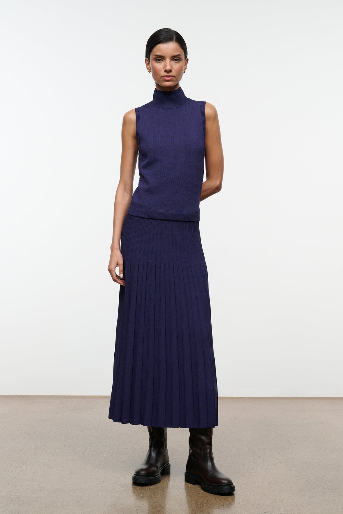 Midnight sleeveless turtleneck knit top with ribbed hem, deep navy blue