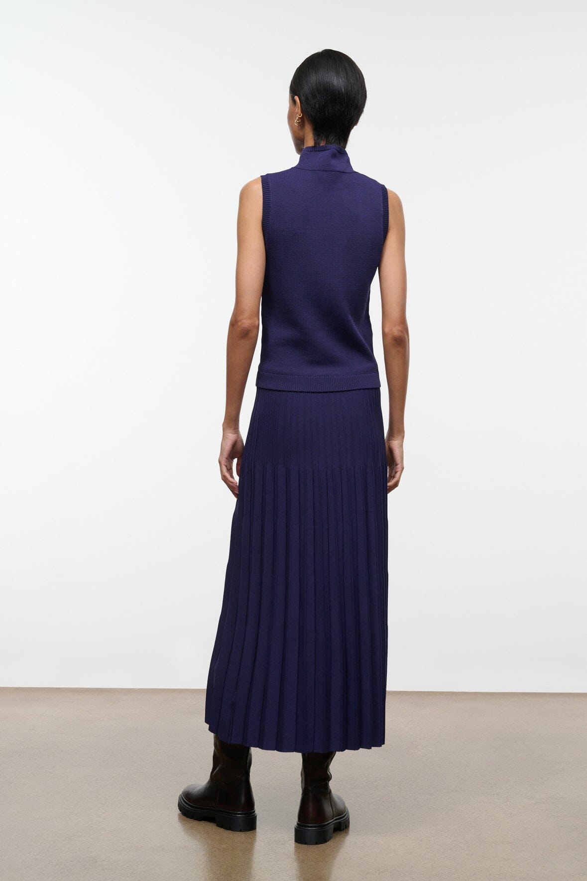 Midnight pleated midi skirt, back view, elastic waistband