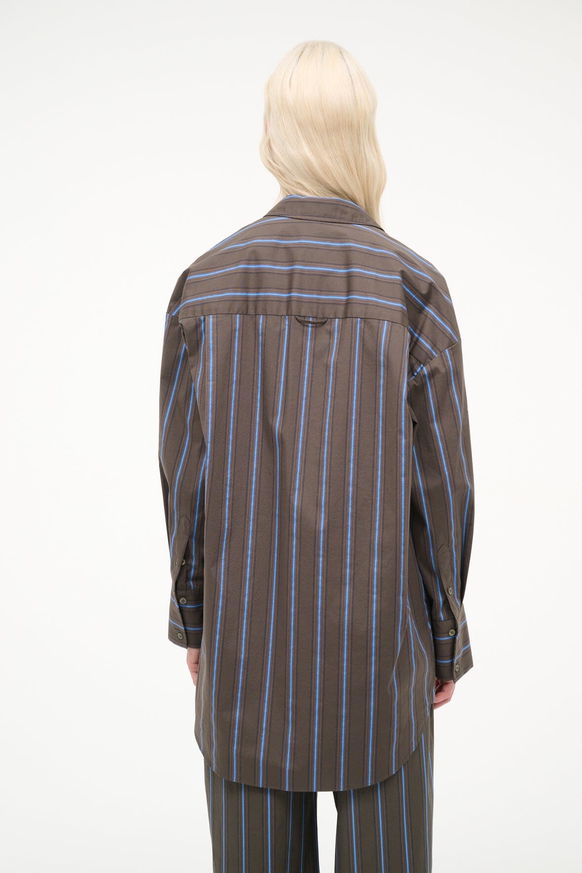 Back view of dark vertical stripe button-up top with long sleeves and collar