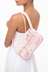 Beaded mini shoulder bag worn on shoulder with pink cherry blossom toile pattern