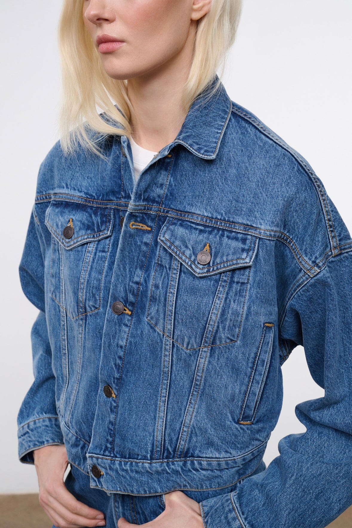 Vintage-wash blue denim jacket with button-flap chest pockets and front seam detailing