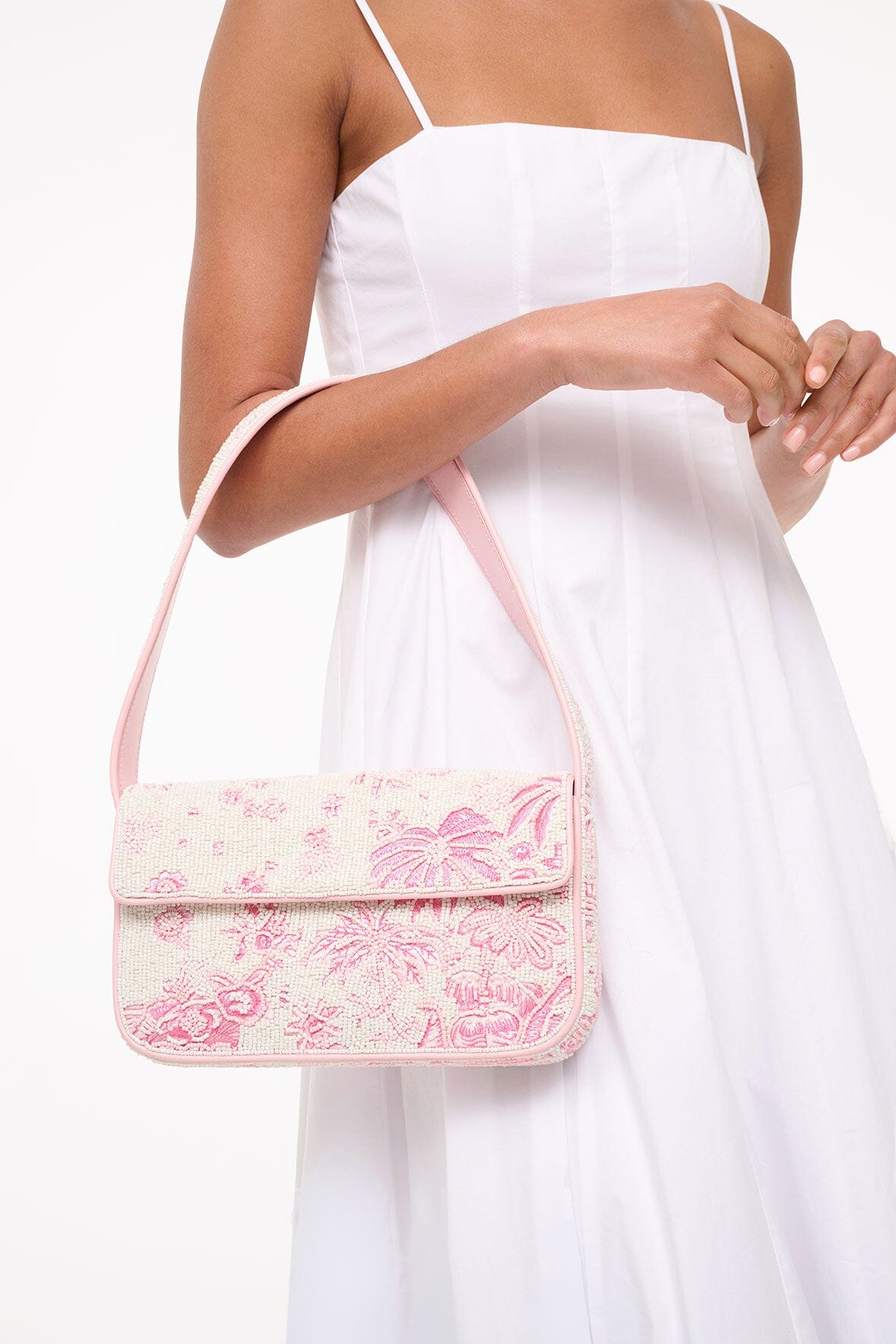 Beaded mini handbag worn crossbody style with pink cherry blossom toile print