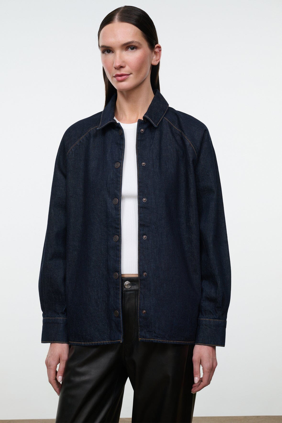 Indigo denim shirt jacket with button-up front, pointed collar, and chest welt pockets