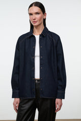 Indigo denim shirt jacket with button-up front, pointed collar, and chest welt pockets