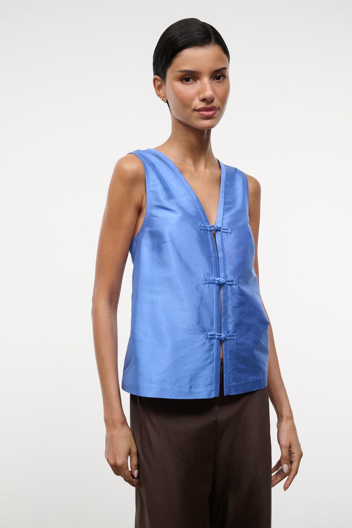 Light blue silk dupioni sleeveless top with V-neck and decorative frog fastenings
