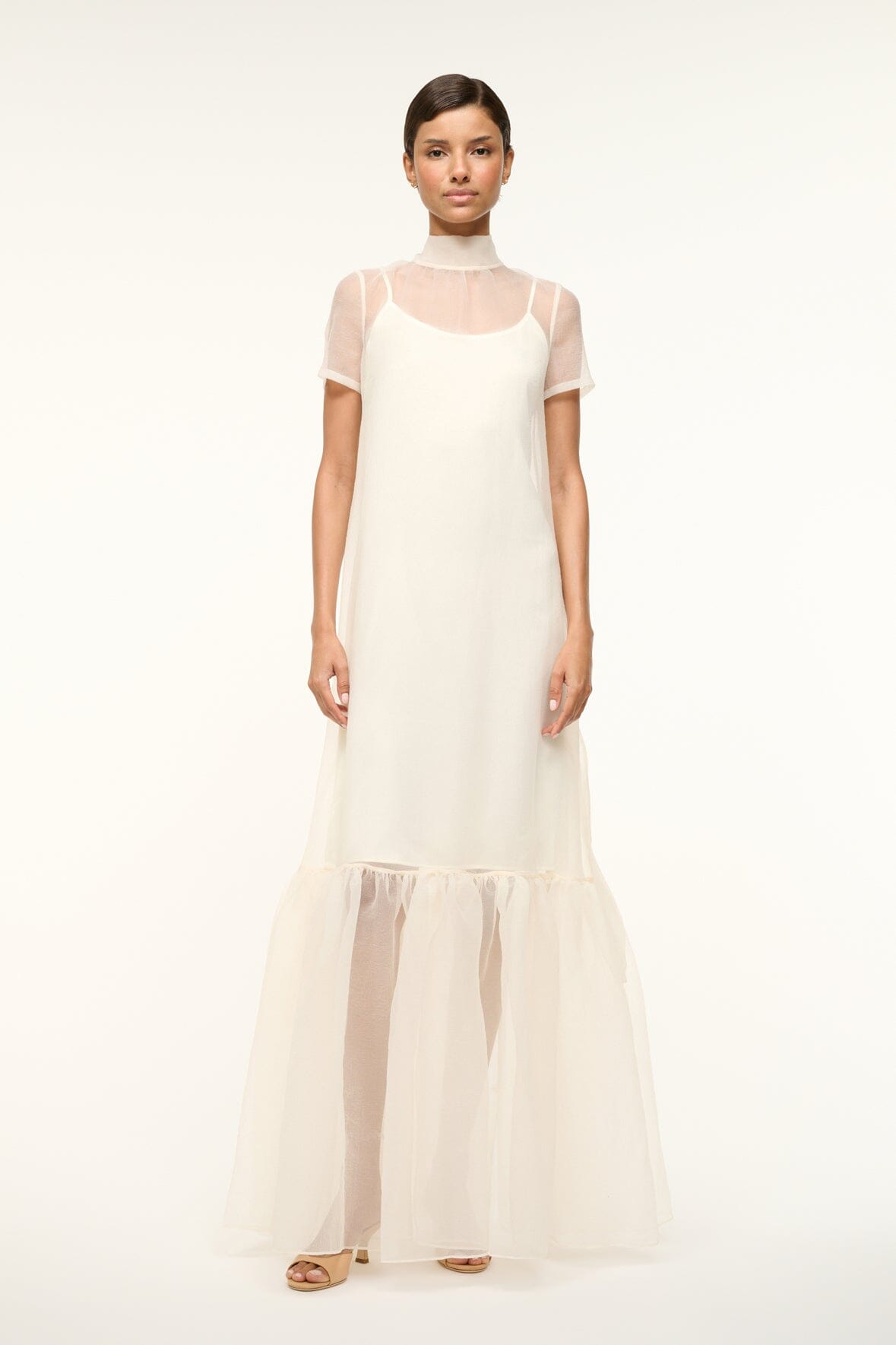 White maxi dress with spaghetti straps, sheer yoke, and tiered hem