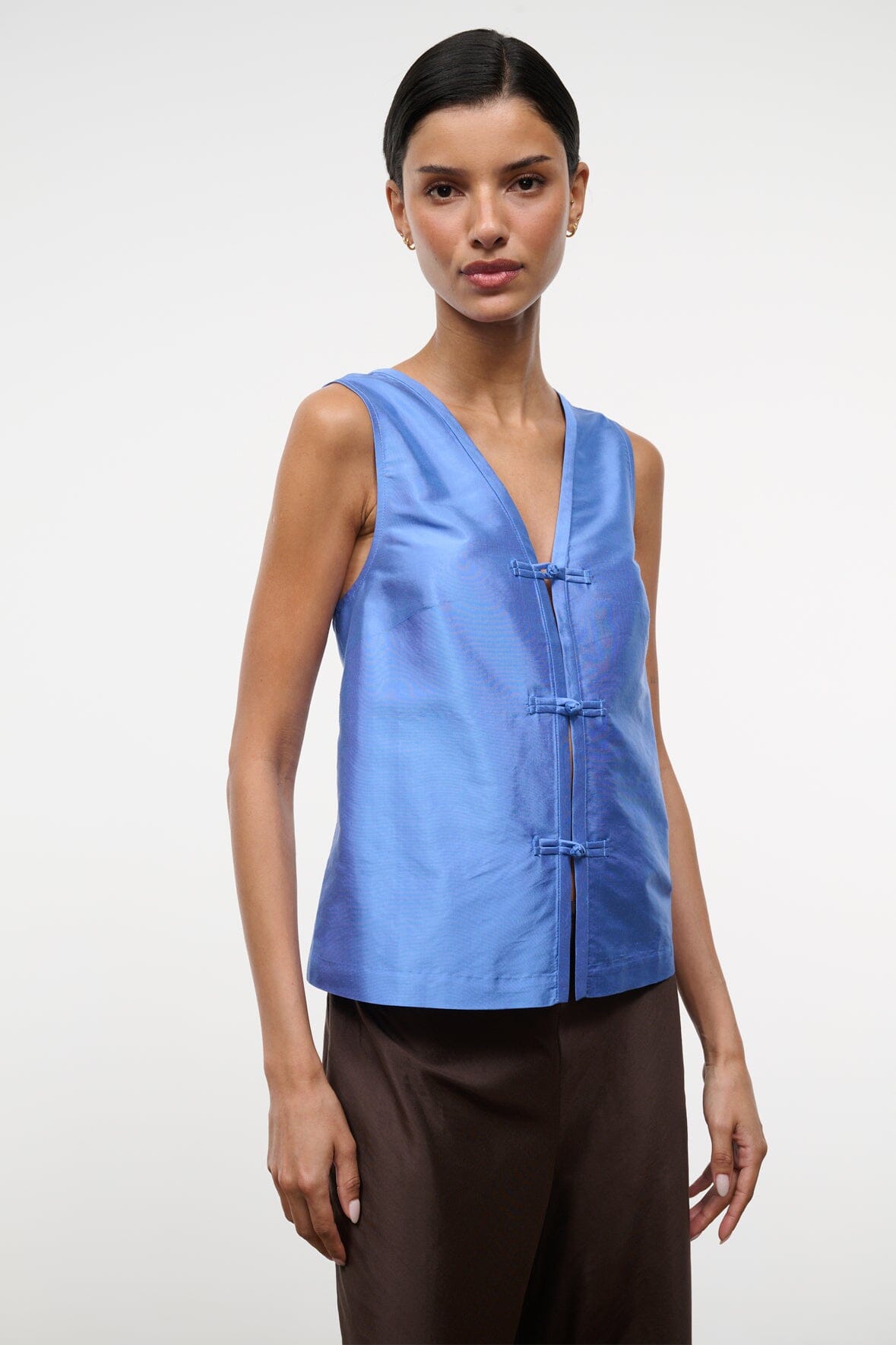 Light blue silk dupioni sleeveless V-neck top with vertical button placket