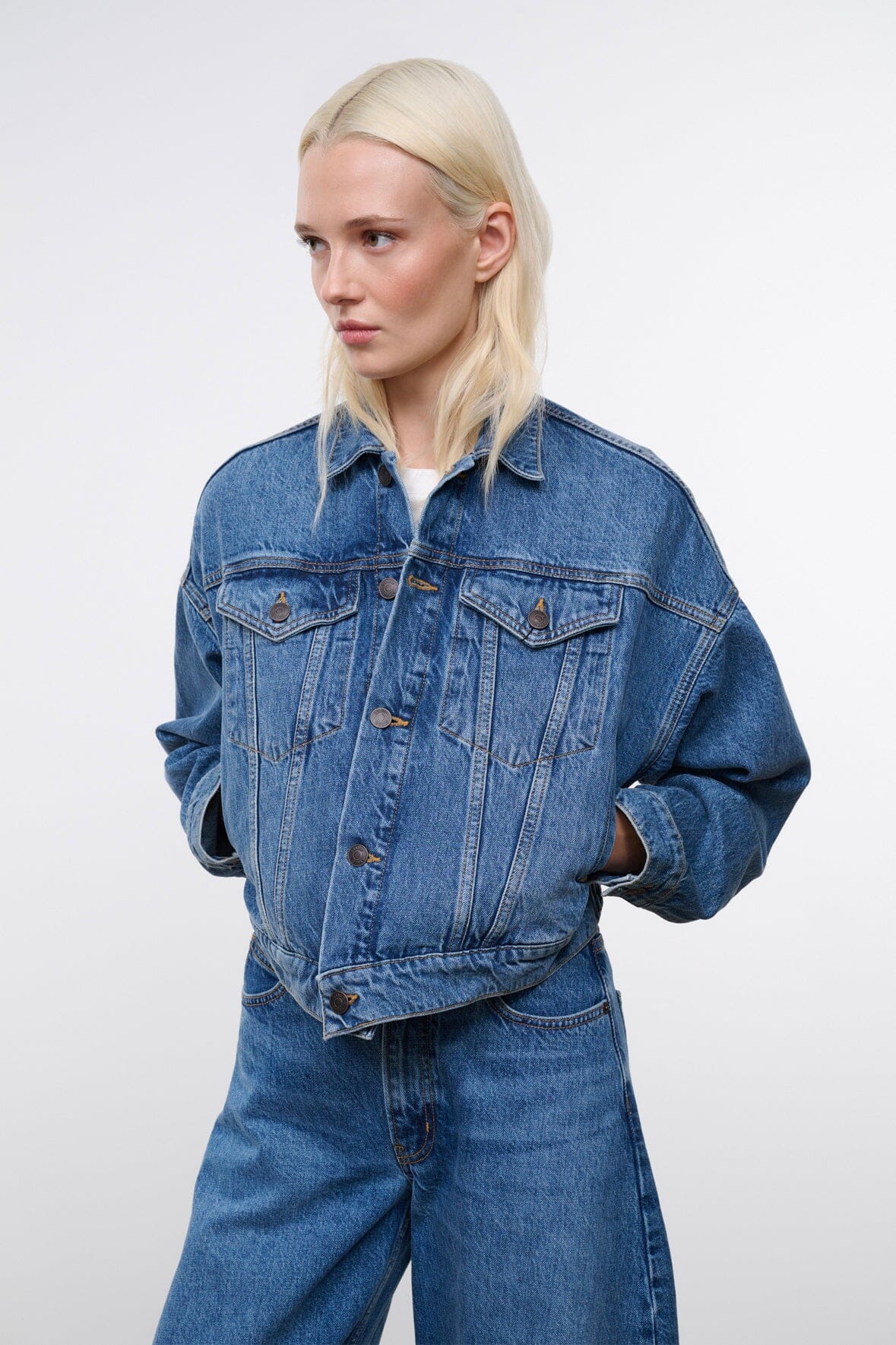 Vintage-wash blue denim jacket with long sleeves and button-flap chest pockets