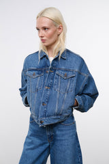 Vintage-wash blue denim jacket with long sleeves and button-flap chest pockets