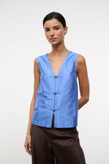 Light blue silk dupioni sleeveless top with V-neck and frog closure front