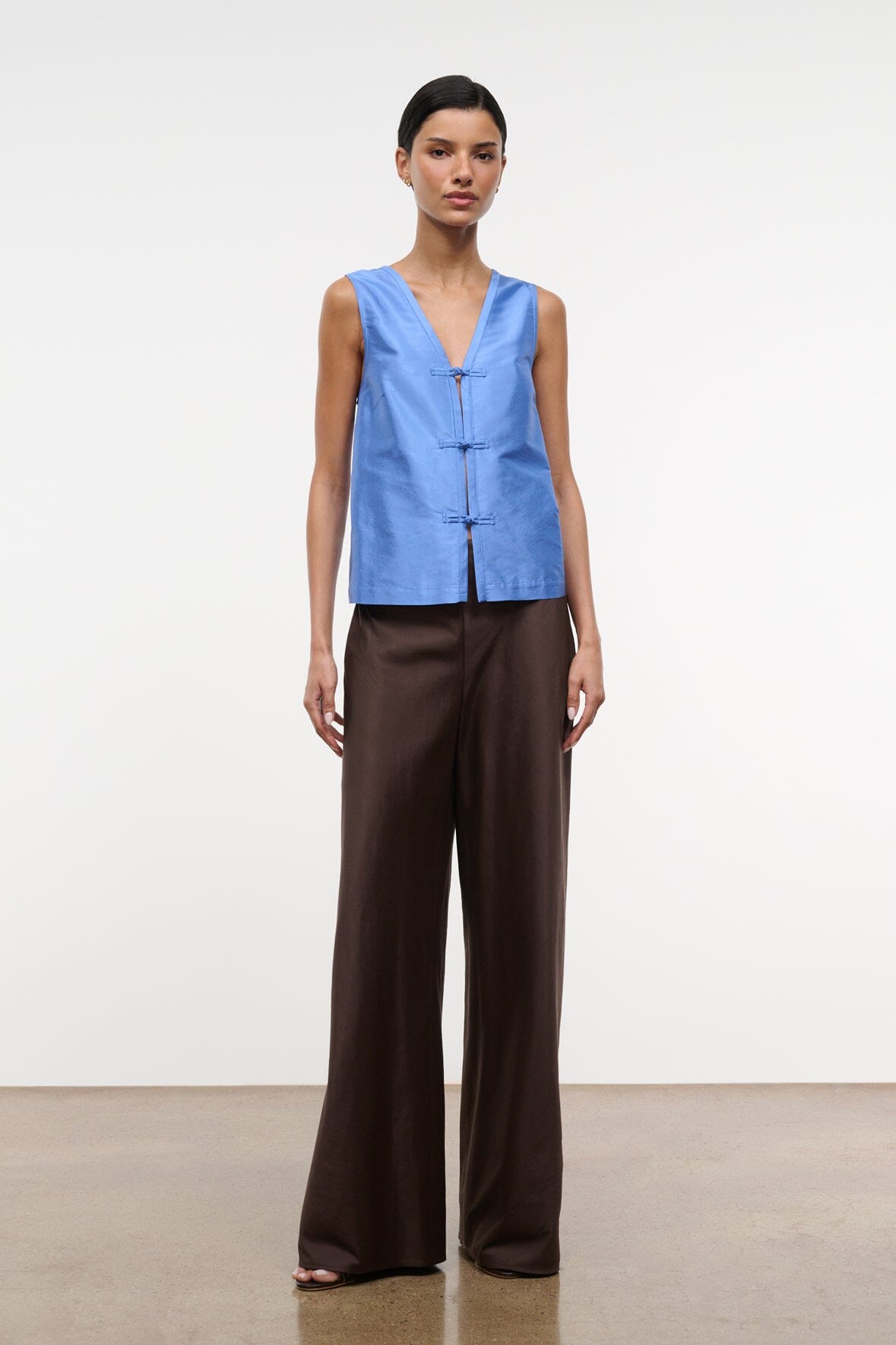 Light blue silk dupioni sleeveless top with V-neck and frog closures