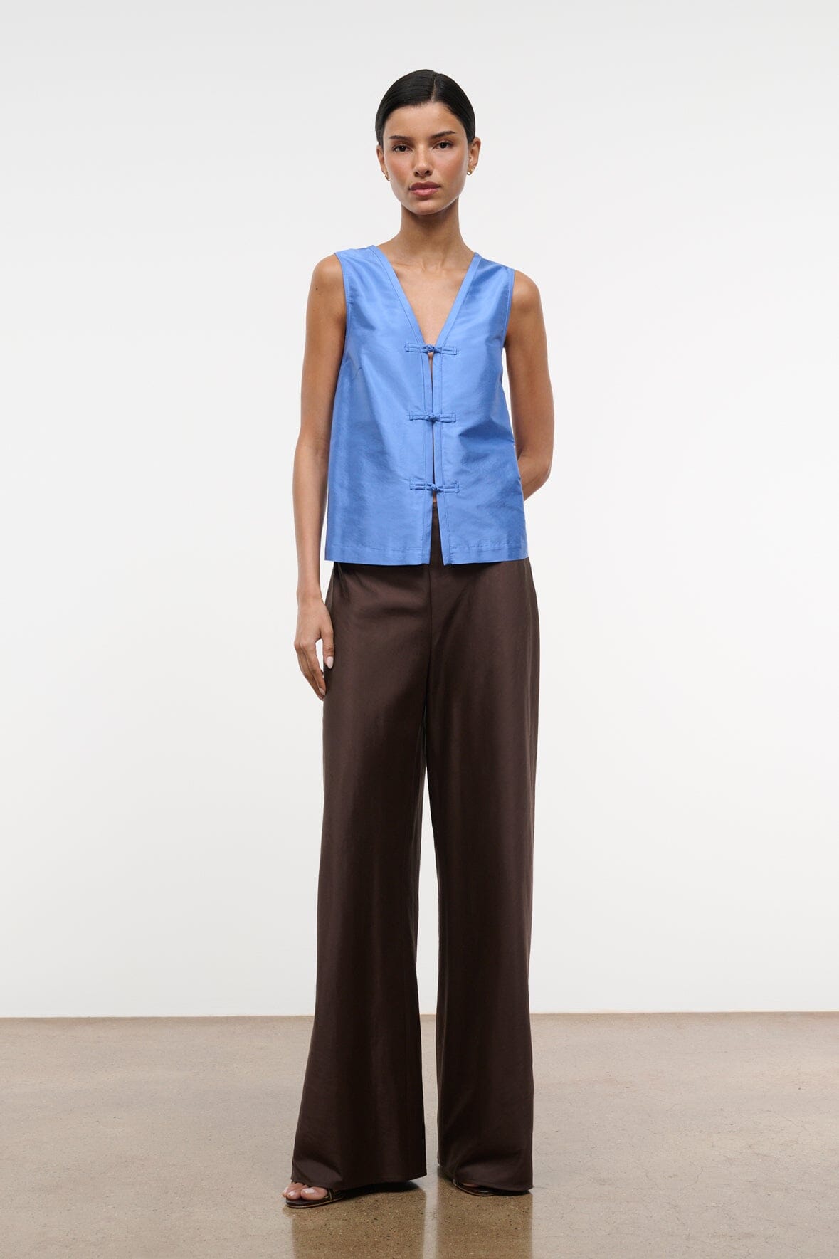 Light blue silk dupioni sleeveless top, front view with V-neck frog fastenings