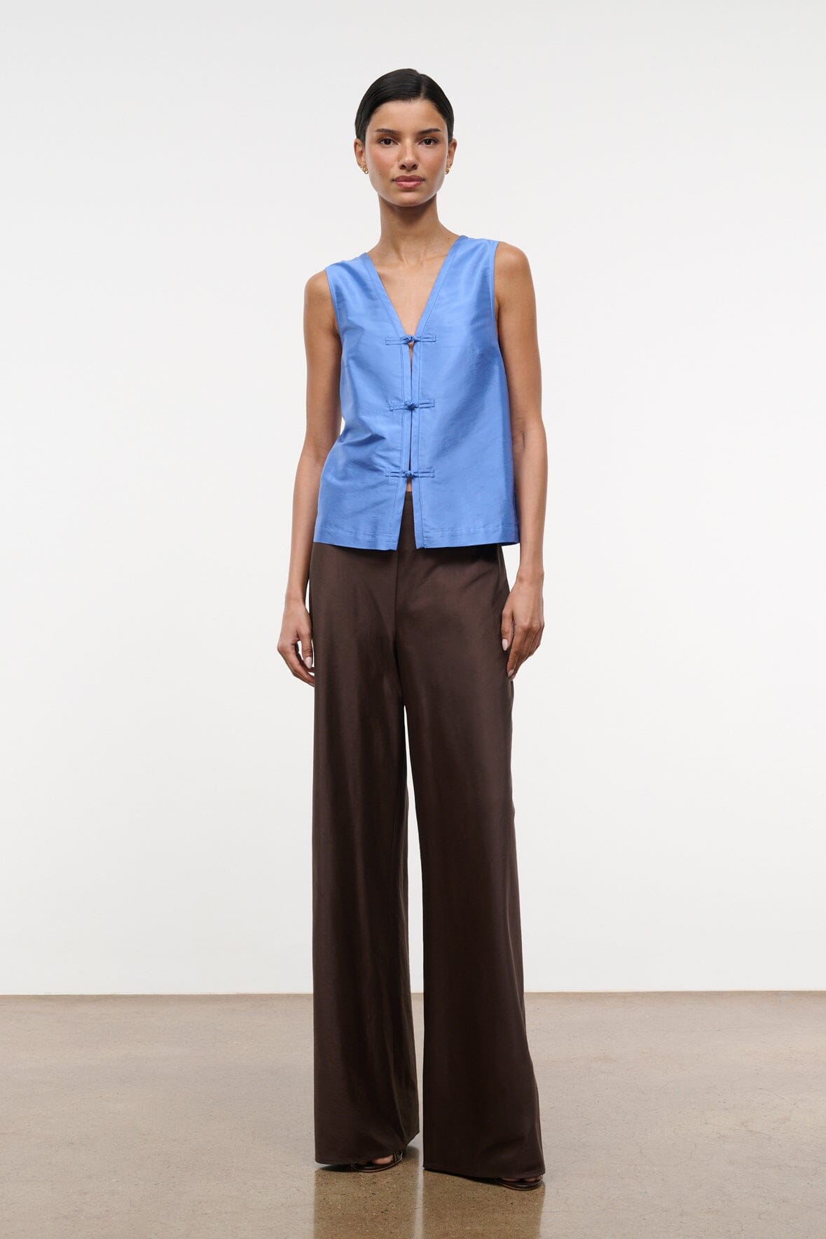 Light blue silk dupioni sleeveless top with V-neck and vertical placket