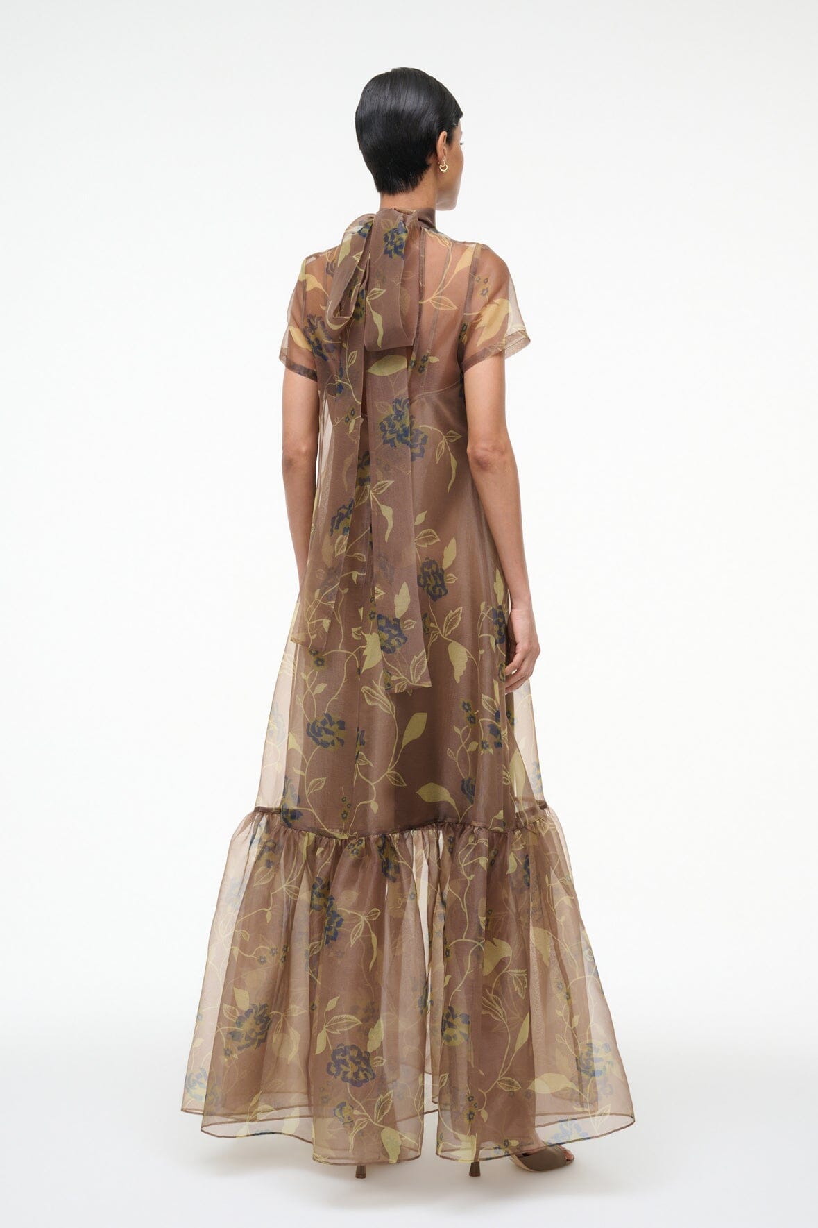 Back view of brown vintage floral sheer maxi dress with high neck and tiered ruffle hem