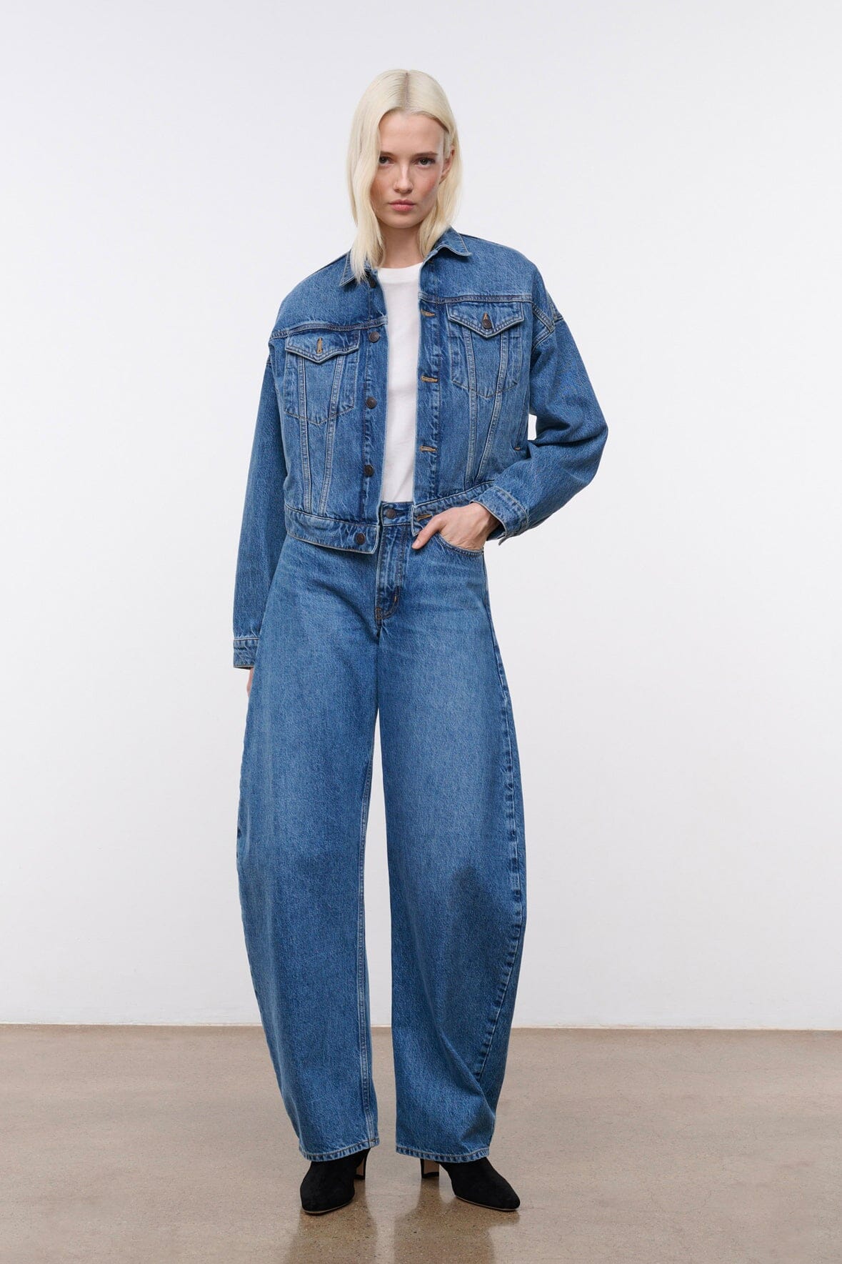 Vintage-wash blue denim jacket with button front, denim collar, and two flap chest pockets