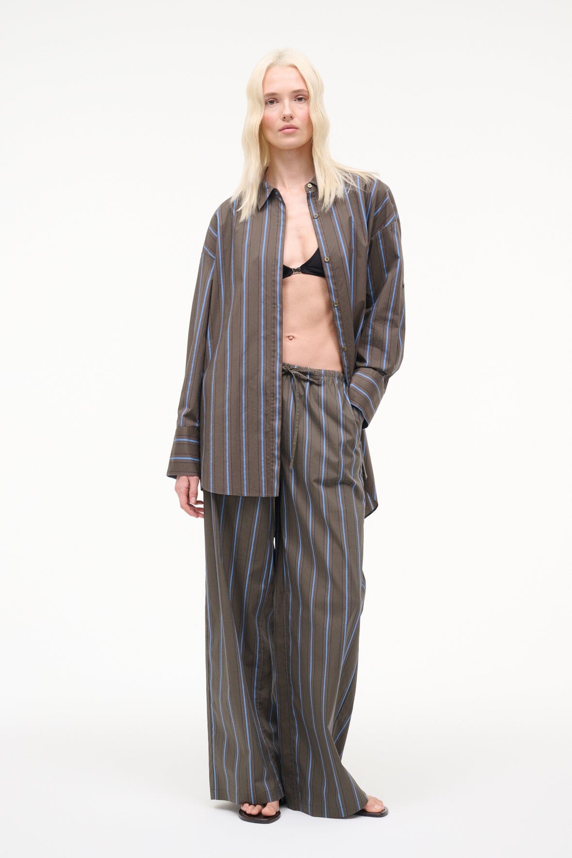 Dark vertical striped wide-leg pants with drawstring waist, straight relaxed legs.
