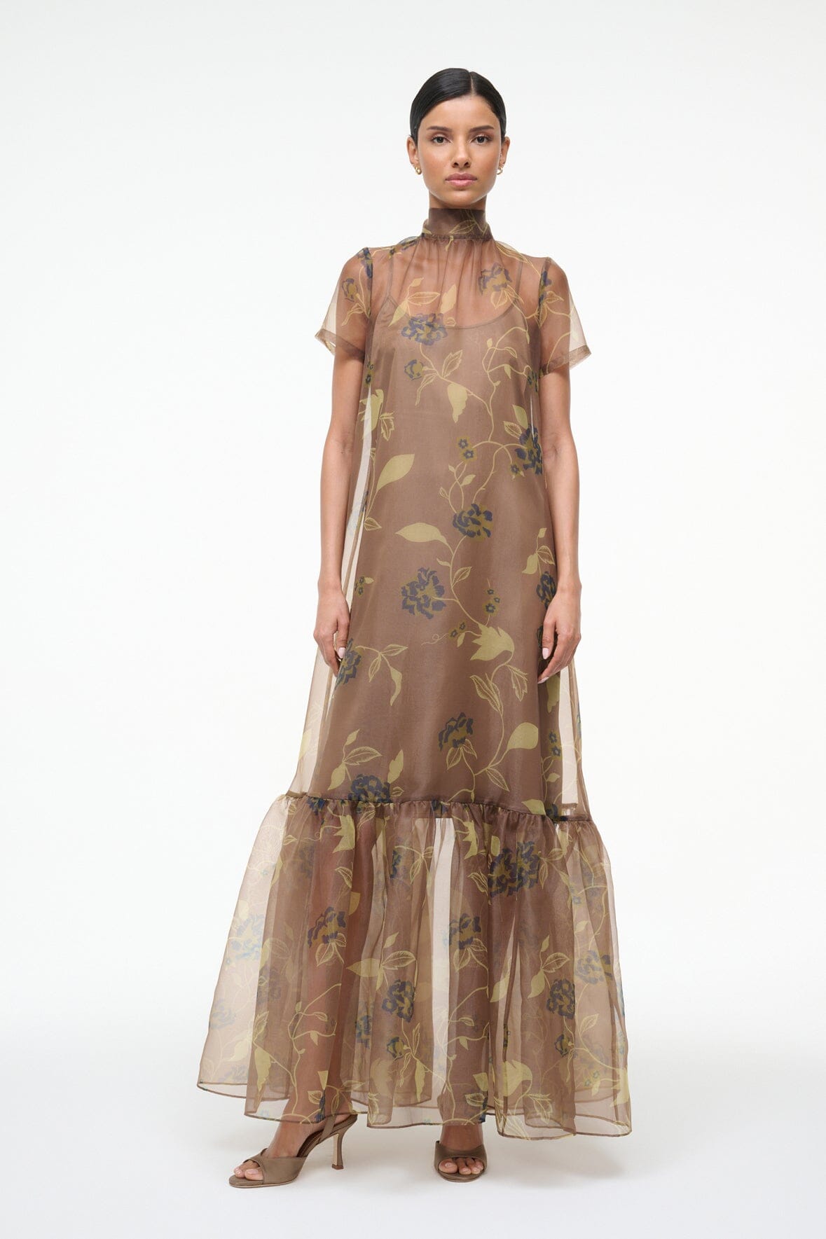 Front view of brown sheer maxi dress with vintage floral print and tiered ruffle hem