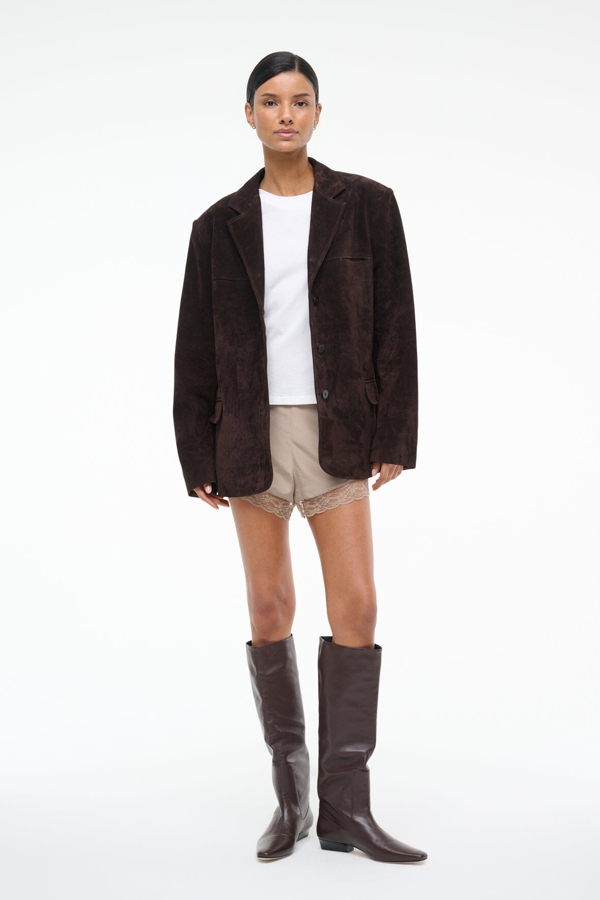 Women's espresso-brown suede jacket worn with tall dark boots and lace-trim shorts