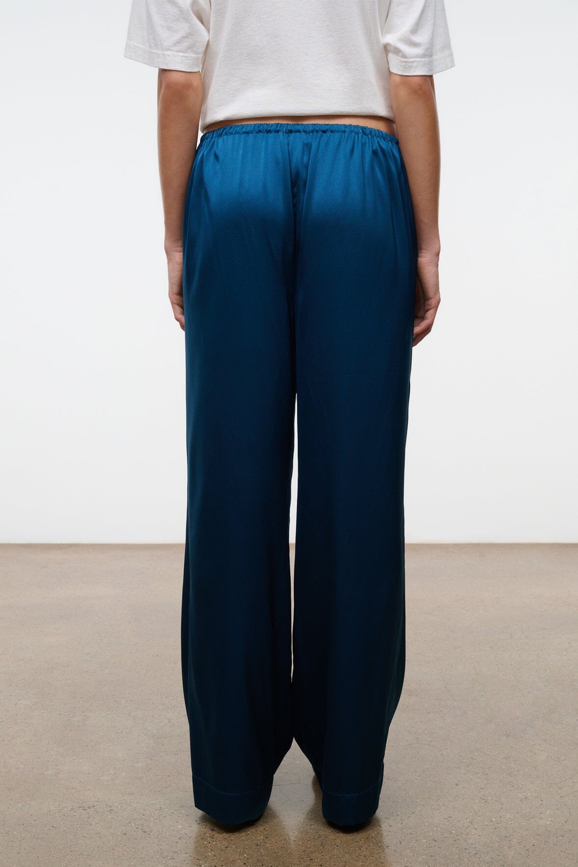 Back view of blue silk wide-leg pant with smooth seat and relaxed legs
