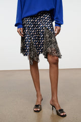 Silk skirt close-up: navy multicolor dot print with fringed asymmetric tiers