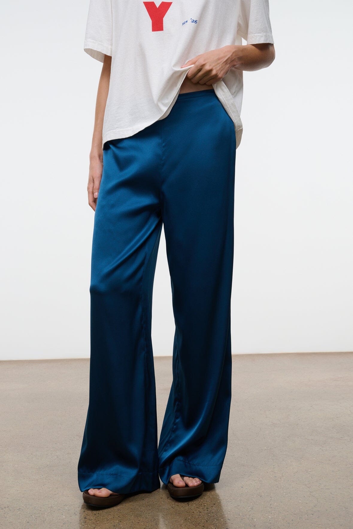 Blue silk wide-leg pant with flowing fabric and wide flared hem
