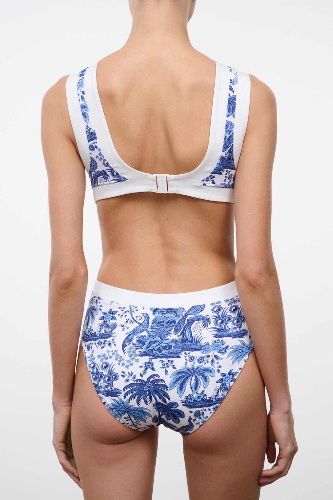 Blue toile one-piece swimsuit back view with racerback straps and white contrast trim.