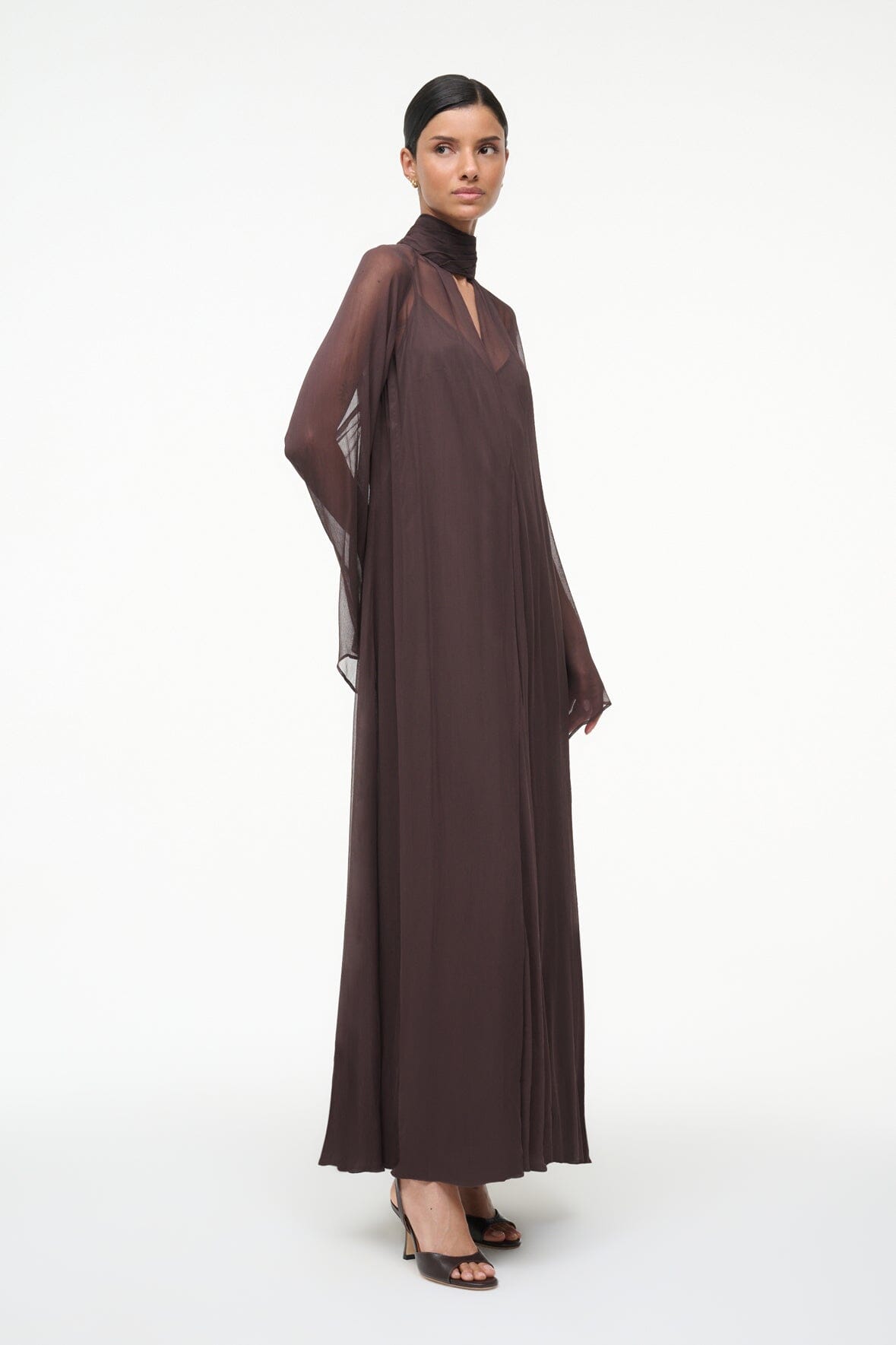 Brown maxi dress with draped high neck scarf and flowing, sheer sleeves