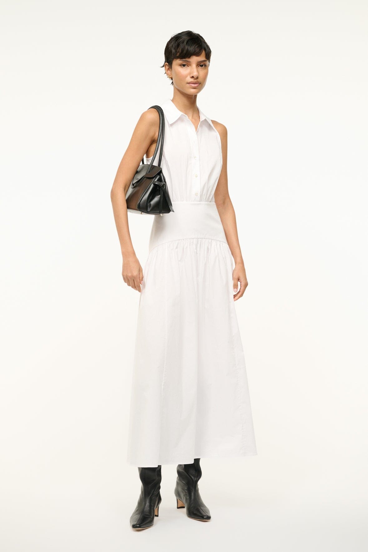 White sleeveless collared dress with buttoned front and gathered tiered skirt