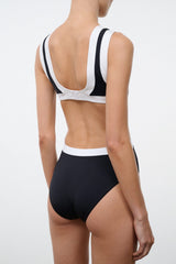 Black one-piece swimsuit with white-trimmed racerback and scooped back neckline