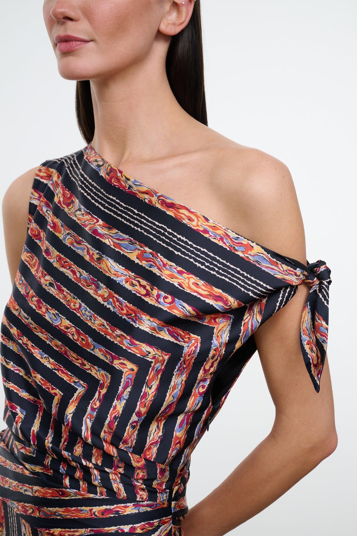 Silk dress bodice close-up, black rust and cream geometric stripes, draped asym neckline