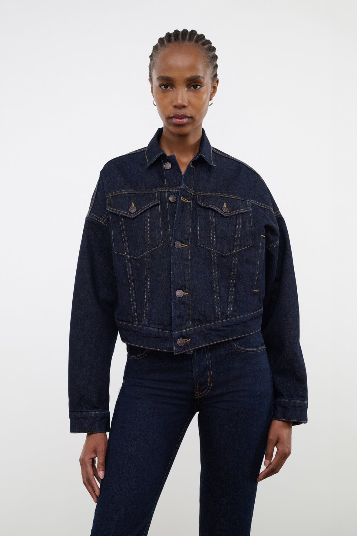 Indigo denim jacket with button front, pointed collar, flap chest pockets, dark wash