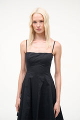 Black mini dress with spaghetti straps and square neckline, fitted bodice, pleated skirt