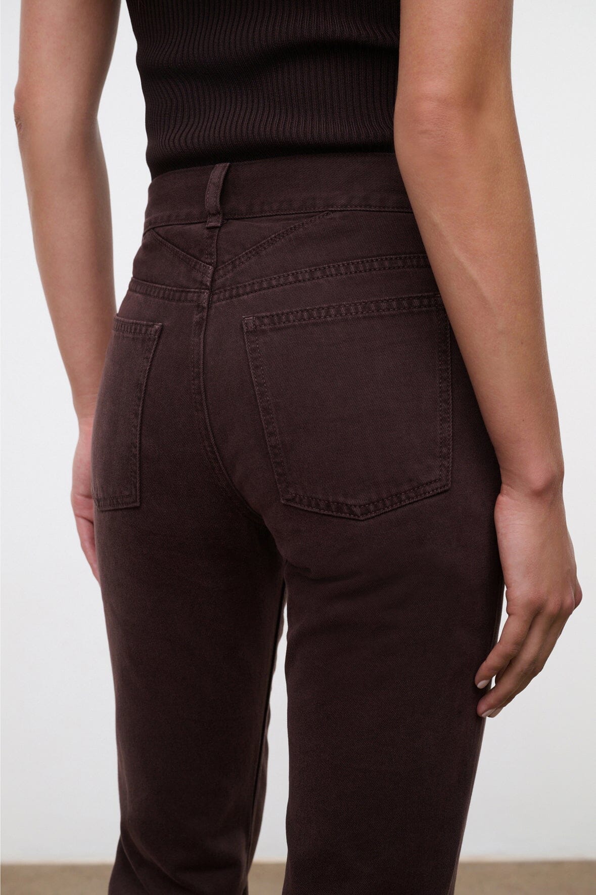 Dark brown straight jeans with back yoke and patch pockets