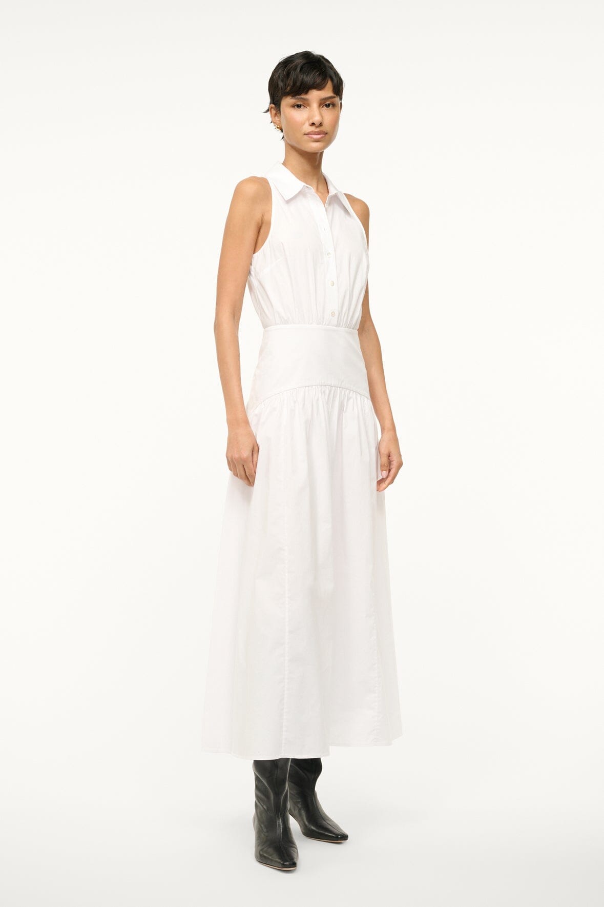 White sleeveless dress with collared top and fitted waist with layered skirt