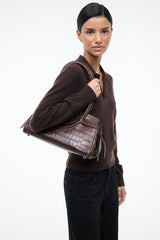 Espresso brown croc-texture shoulder bag with long strap and flap front