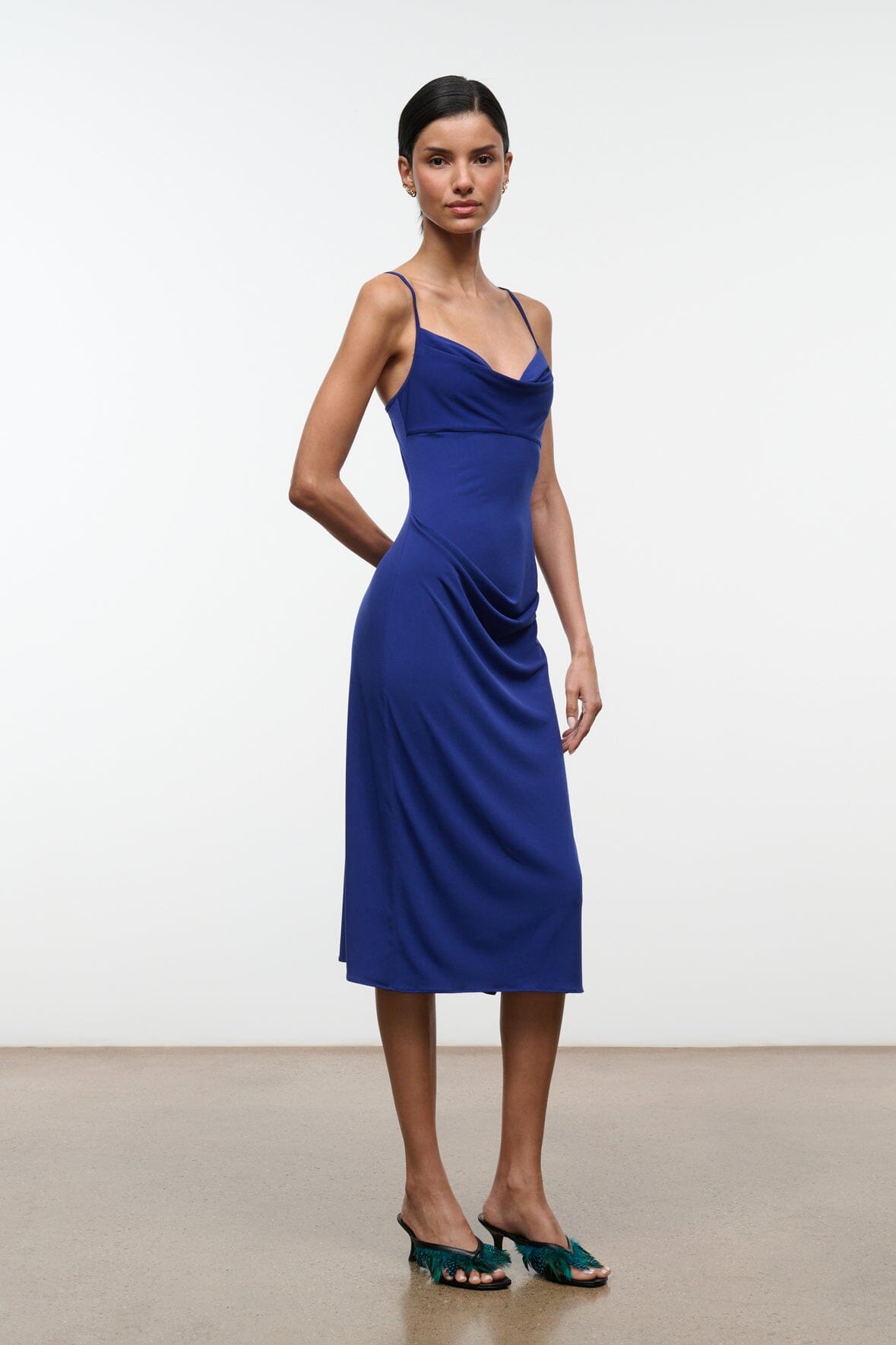 Midnight blue midi dress with cowl neckline and thin straps, side drape