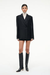 Black western boots worn with a blazer dress, pointed toe and slim heels
