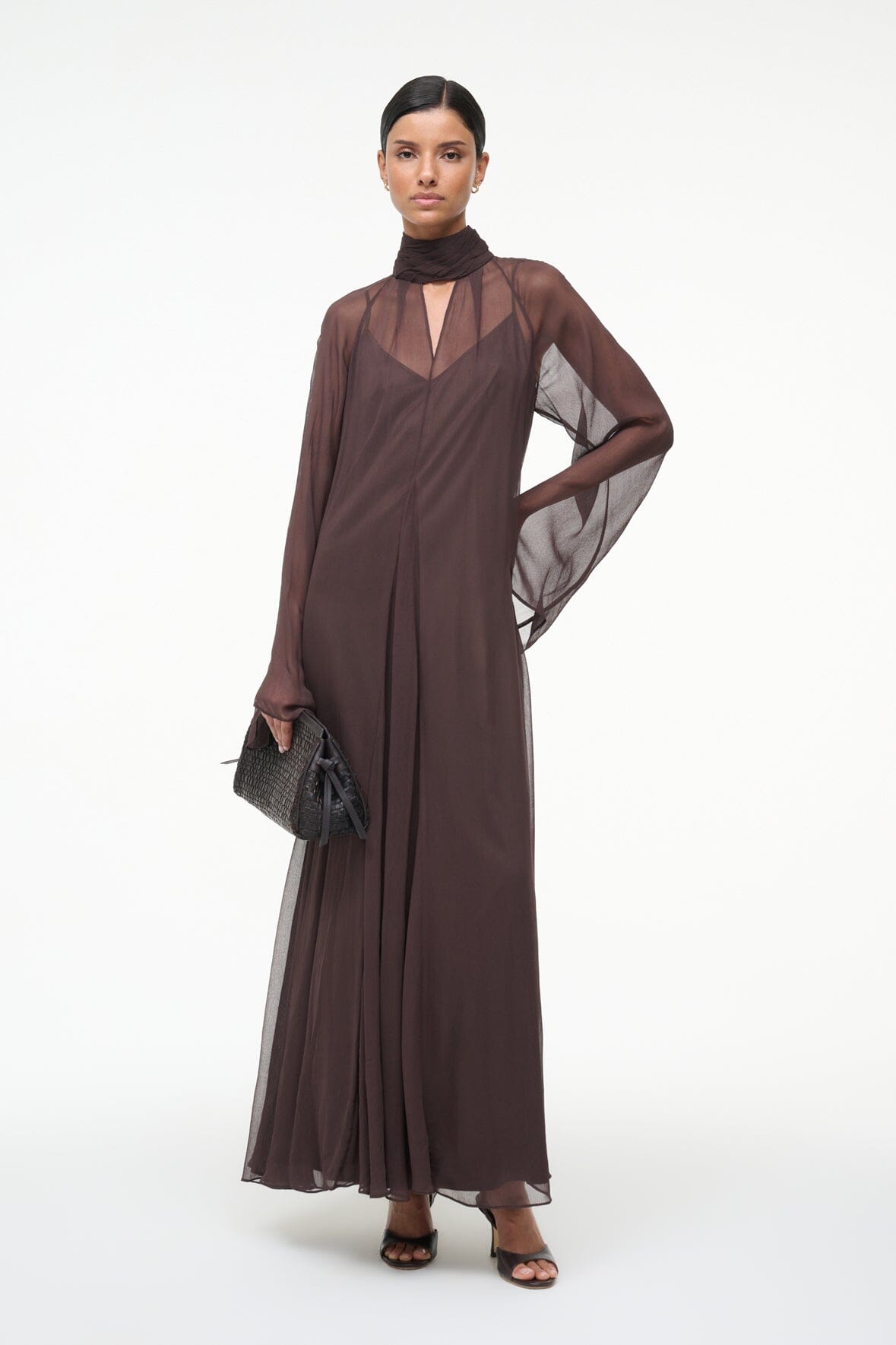 Brown maxi dress with high neck scarf, sheer sleeves, and side drape detail