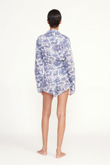 Back view of blue and white toile shorts with elastic waist and ruffled hem