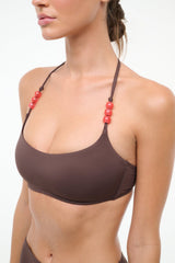 Dark chocolate bikini top with halter straps and red bead trim, front view