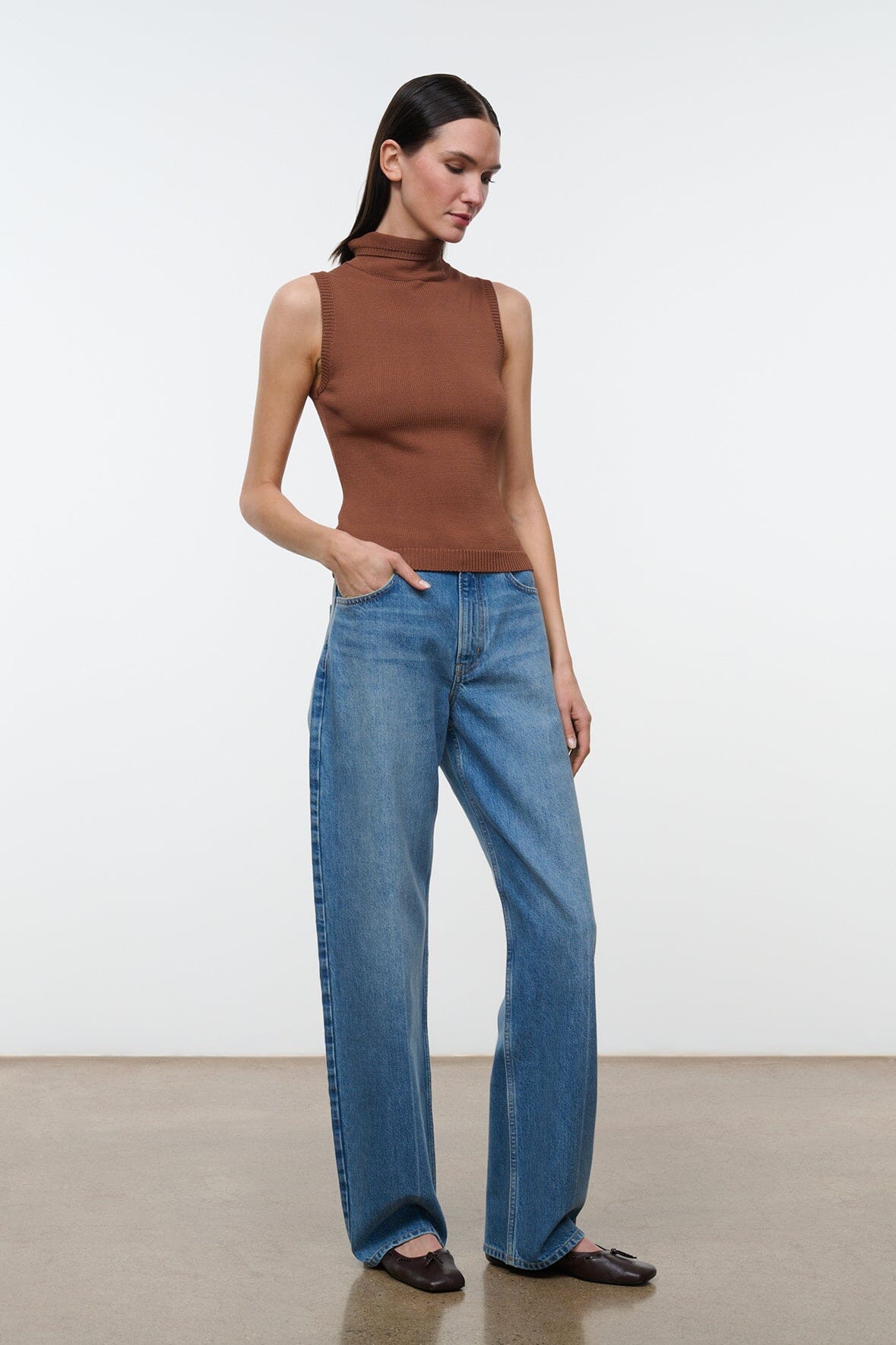 Brown sleeveless mock-neck knit top with ribbed texture, side view